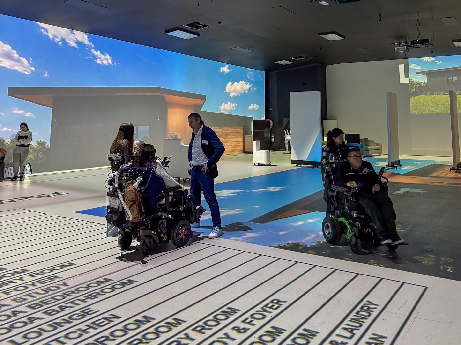 Participants, families, Occupational Therapists and support teams walking through a full-scale SDA floor plan at Lifesize Plans in Burwood